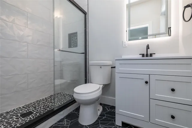 a bathroom with a sink toilet and shower