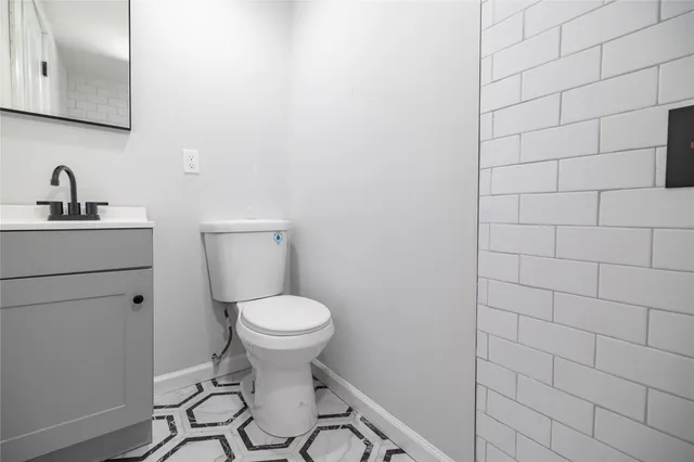 a bathroom with a sink toilet and a mirror