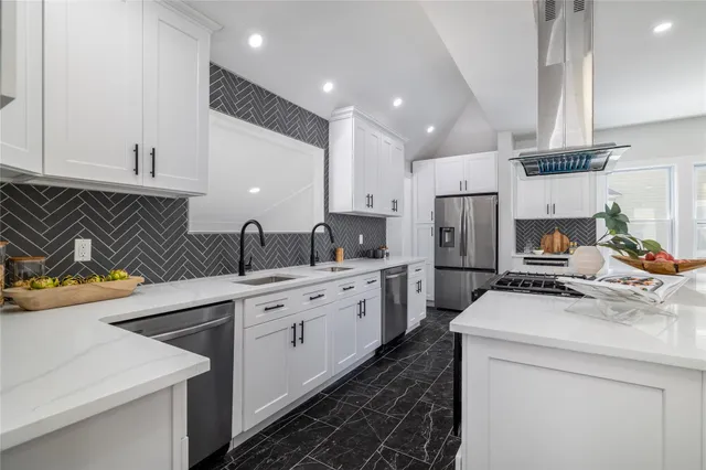 a kitchen that has a sink and a stove in it