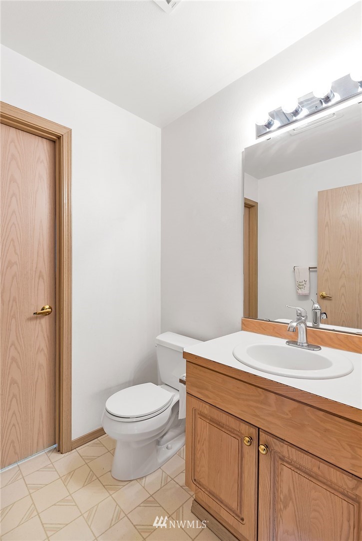 706 203rd Street Southeast Bothell, WA 98012 - Photo 11 of 21 a bathroom with a sink a toilet and a mirror