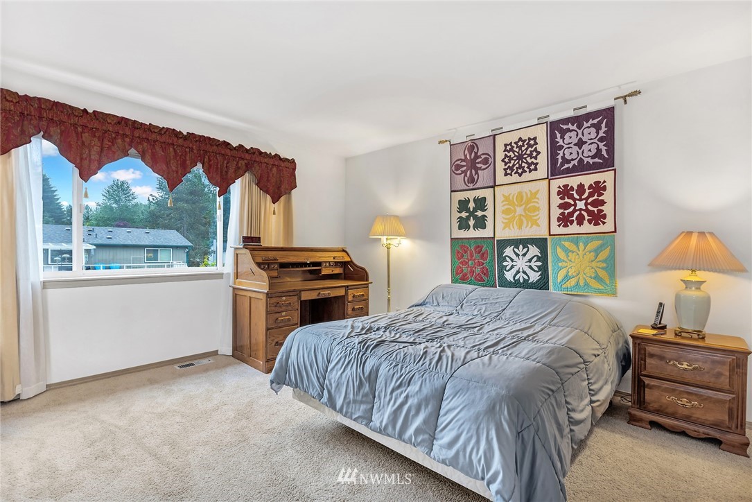 706 203rd Street Southeast Bothell, WA 98012 - Photo 13 of 21 a bedroom with a bed and a large window