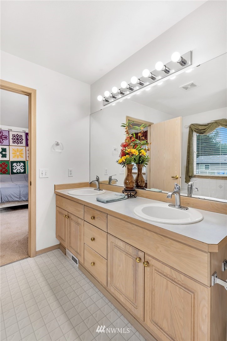 706 203rd Street Southeast Bothell, WA 98012 - Photo 14 of 21 a bathroom with a double vanity sink and a mirror