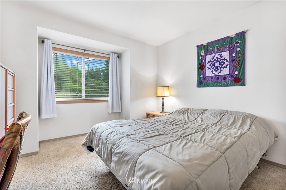 706 203rd Street Southeast Bothell, WA 98012 - Photo 16 of 21 a bedroom with a bed and a painting on the wall