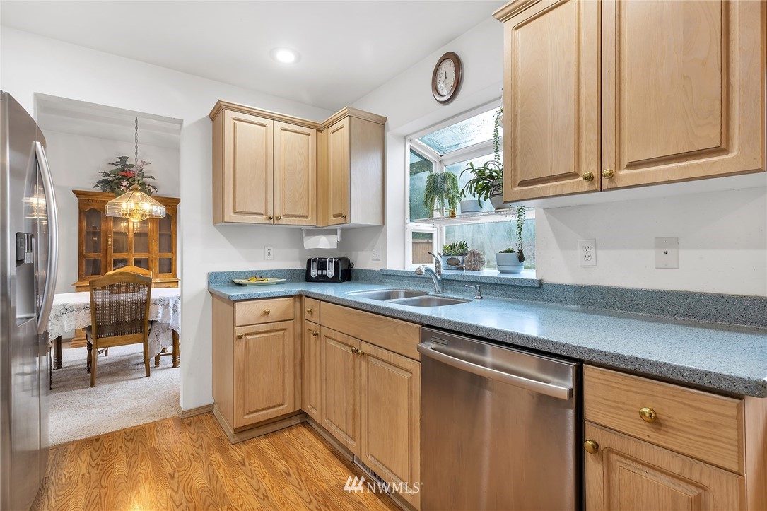 706 203rd Street Southeast Bothell, WA 98012 - Photo 7 of 21 a kitchen with stainless steel appliances granite countertop a sink and cabinets