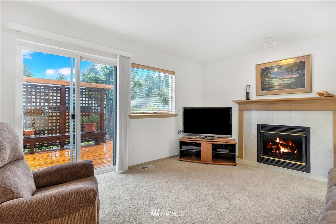 706 203rd Street Southeast Bothell, WA 98012 - Photo 9 of 21 a living room with furniture a flat screen tv and a fireplace