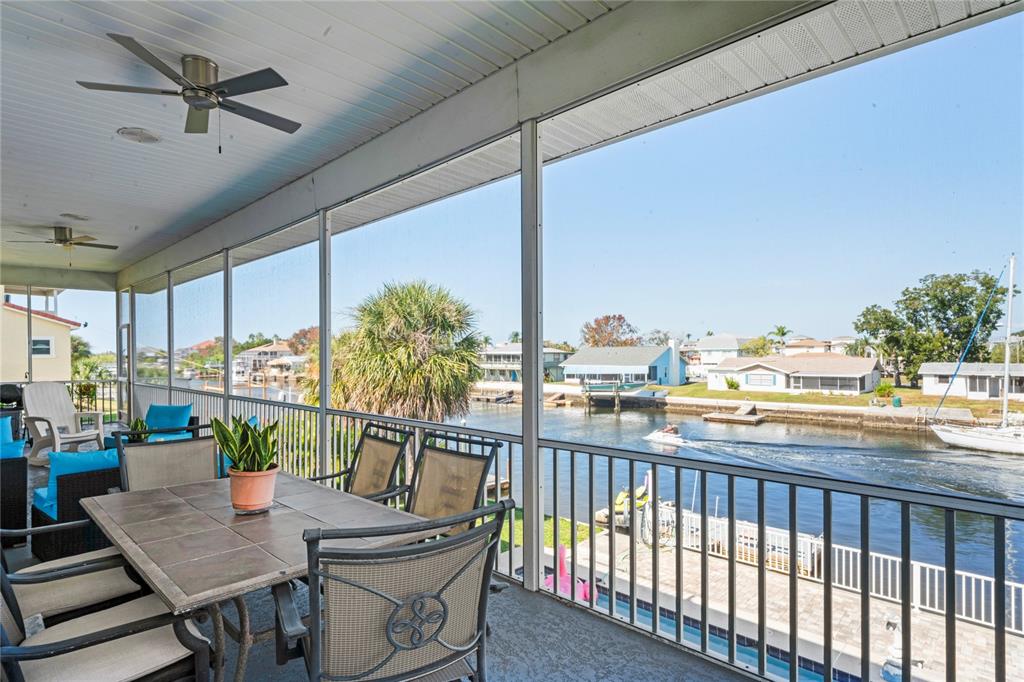 3459 Flamingo Boulevard Hernando Beach, FL 34607 - Photo 17 of 94 a view of a balcony dining table and chairs