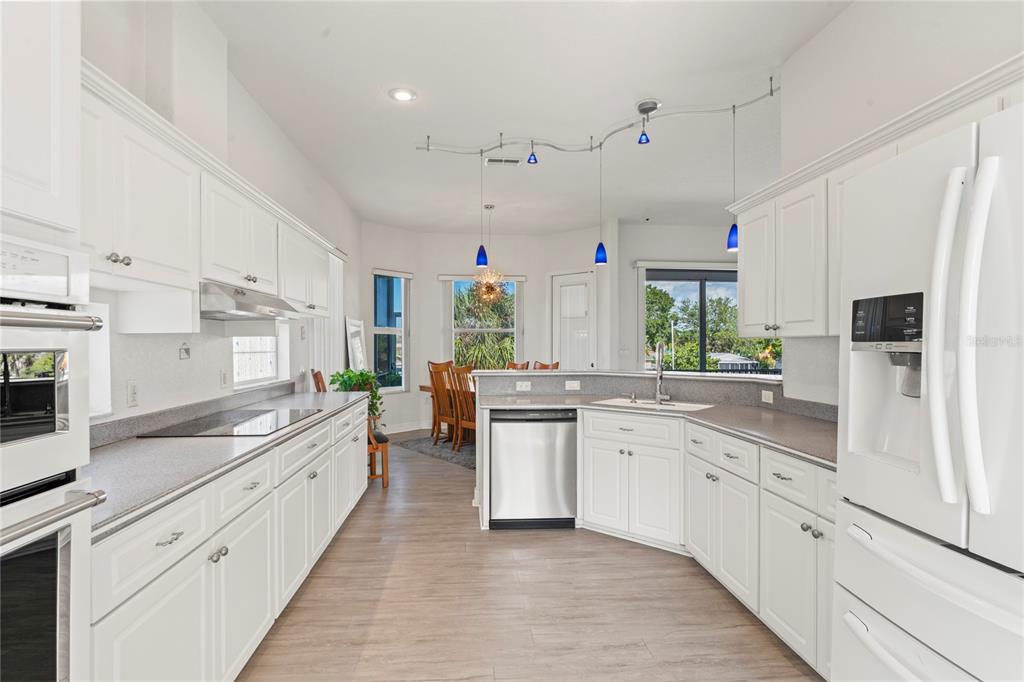 3459 Flamingo Boulevard Hernando Beach, FL 34607 - Photo 20 of 94 a large kitchen with stainless steel appliances kitchen island granite countertop a lot of counter space and wooden floors