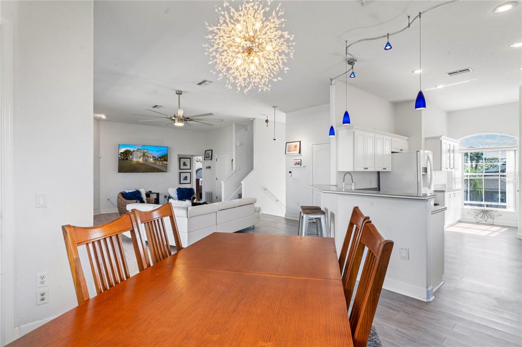 3459 Flamingo Boulevard Hernando Beach, FL 34607 - Photo 24 of 94 a view of a dining room with furniture and wooden floor