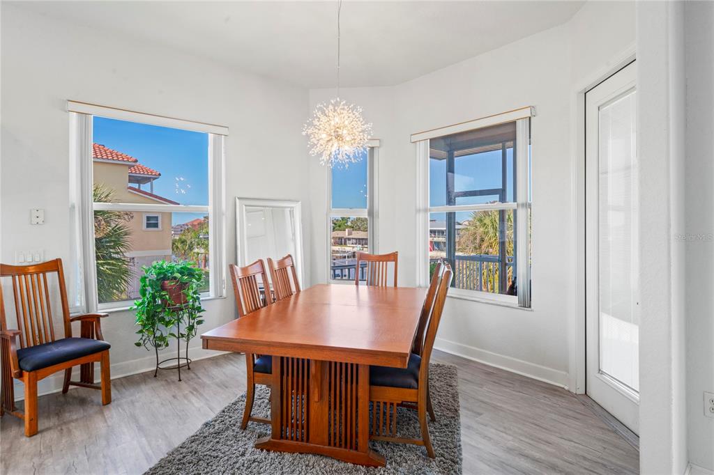 3459 Flamingo Boulevard Hernando Beach, FL 34607 - Photo 25 of 94 a view of a dining room with furniture window and wooden floor
