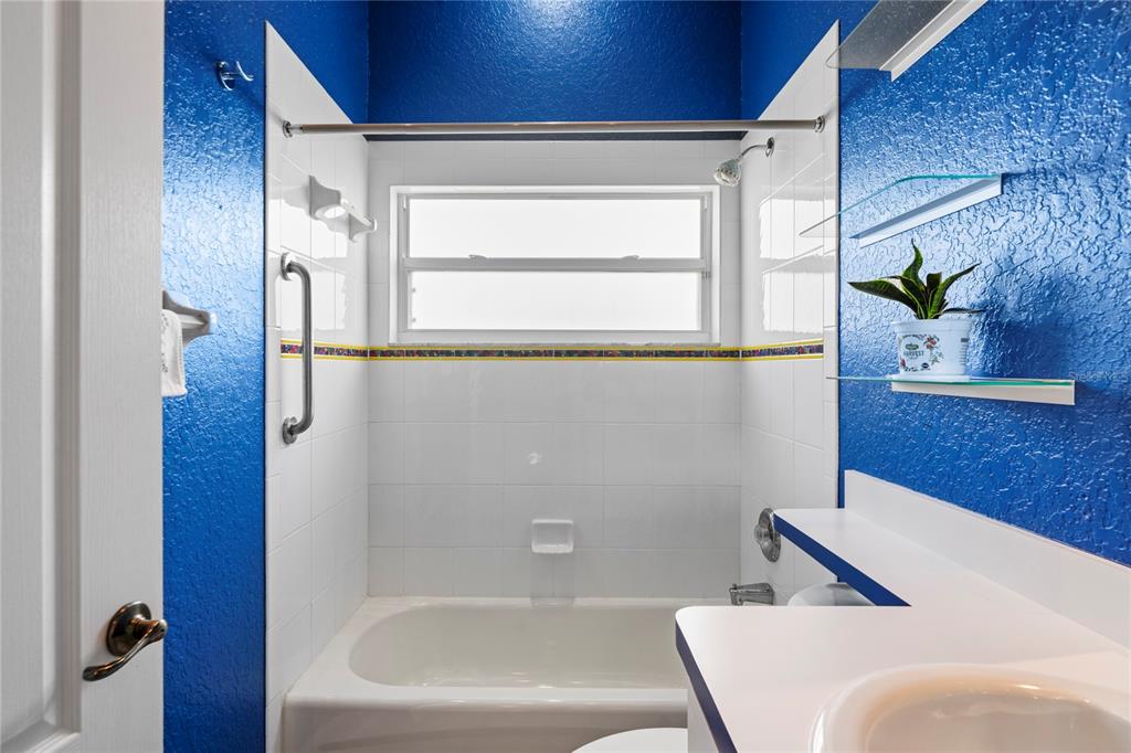 3459 Flamingo Boulevard Hernando Beach, FL 34607 - Photo 33 of 94 a bathroom with a bathtub and a shower