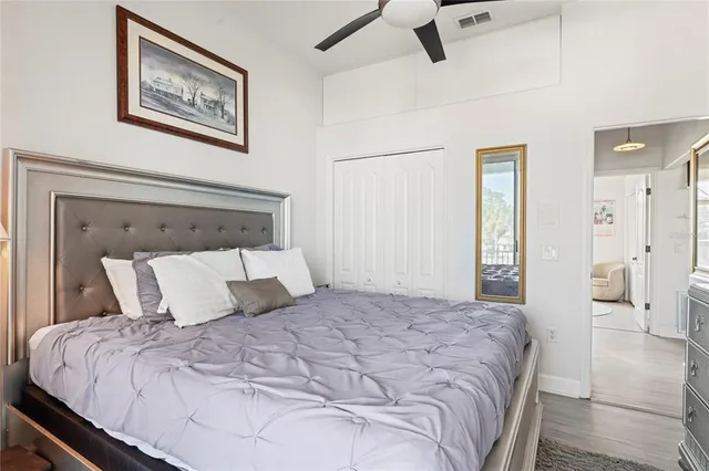 a view of a hallway with wooden floor and dining room