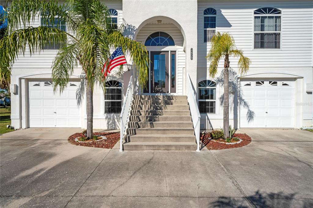 3459 Flamingo Boulevard Hernando Beach, FL 34607 - Photo 5 of 94 a front view of multi story residential apartment building with garage