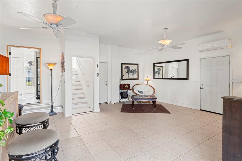 3459 Flamingo Boulevard Hernando Beach, FL 34607 - Photo 54 of 94 a living room with furniture a window and a chandelier