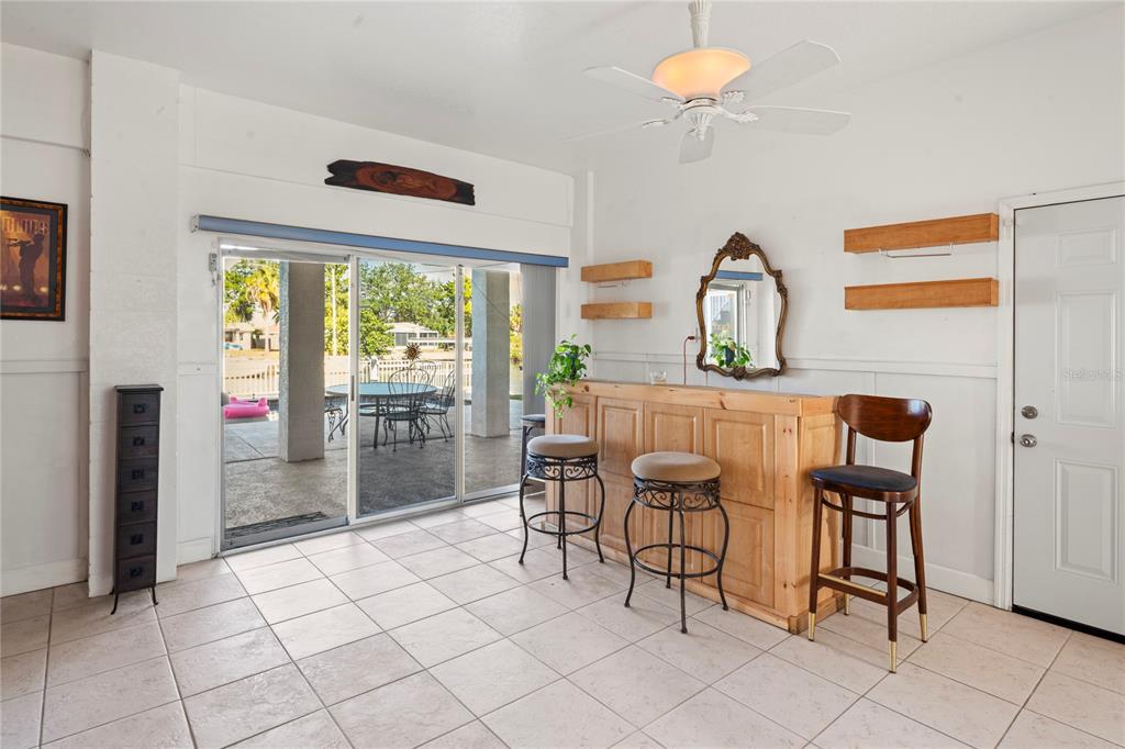 3459 Flamingo Boulevard Hernando Beach, FL 34607 - Photo 62 of 94 a kitchen with stainless steel appliances kitchen island granite countertop a refrigerator and a stove top oven