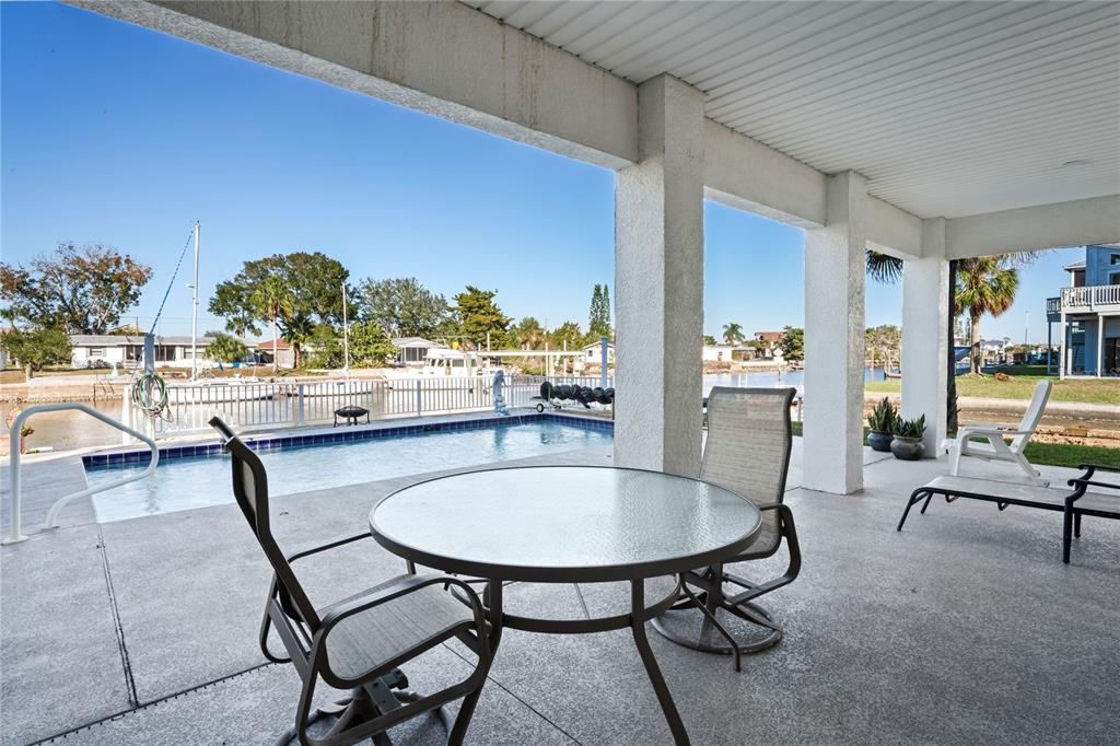 3459 Flamingo Boulevard Hernando Beach, FL 34607 - Photo 65 of 94 a view of a dining room with furniture and a potted plant