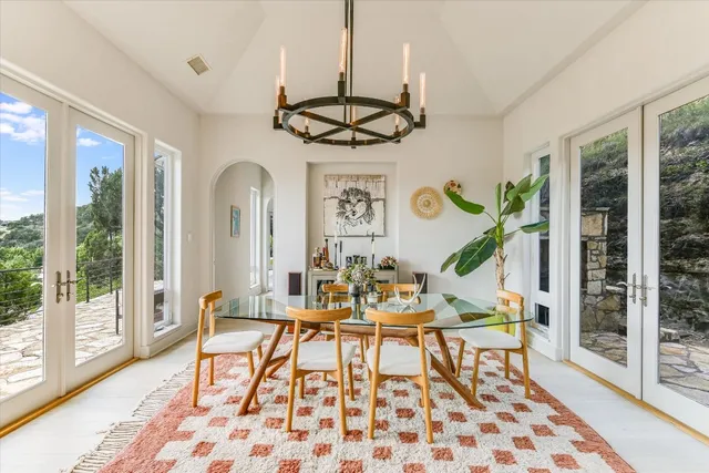 a view of a dining room with furniture wooden floor and chandelier