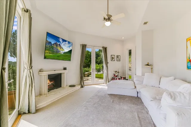 a living room with furniture a fireplace and a flat screen tv