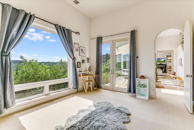a bedroom with furniture and a large window
