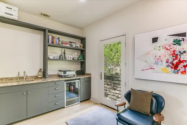 a kitchen with stainless steel appliances granite countertop a couch and a window
