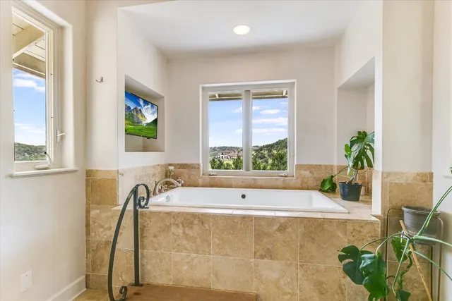 a bath tub sitting in a bathroom next to a window