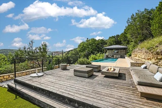 a view of a roof deck with couches and sky view