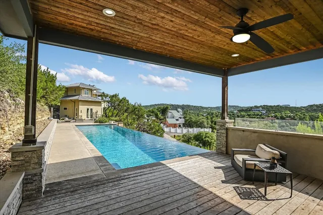 a view of a balcony with chair and wooden floor