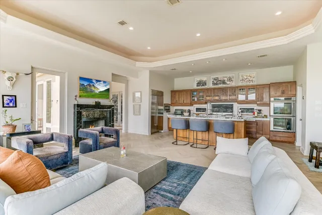 a living room with furniture and a view of kitchen
