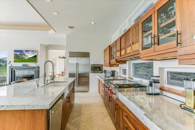 a kitchen with stainless steel appliances granite countertop a sink stove and cabinets