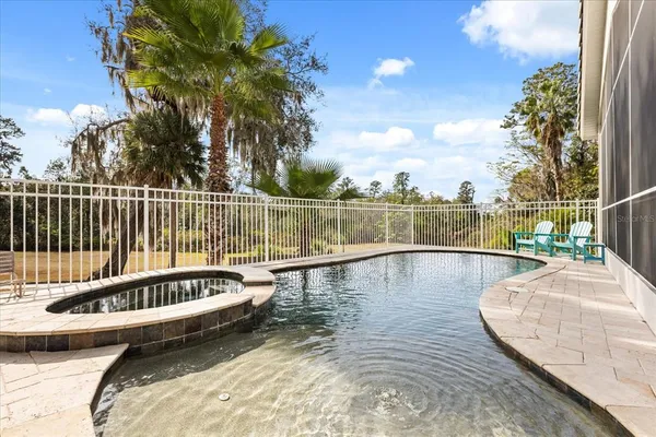a view of swimming pool with outdoor seating and plants