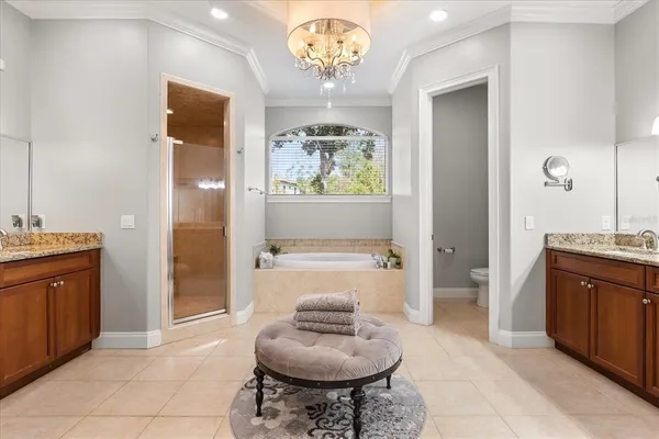 a spacious bathroom with a sink a large mirror and a bathtub