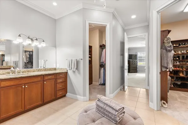 a spacious bathroom with a granite countertop sink a mirror and a shower