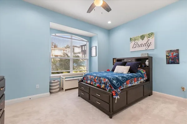 a bed sitting in a bedroom next to a window