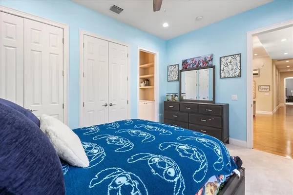 a bedroom with a bed and a dresser