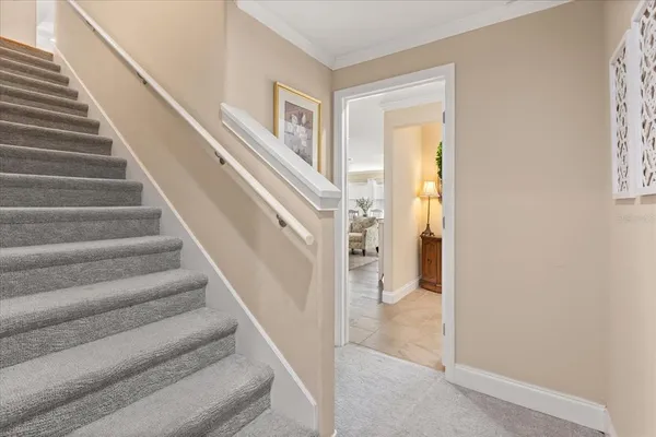 a view of staircase with white walls and windows