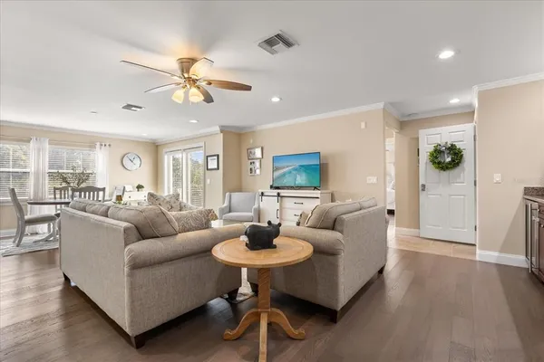 a living room with furniture and a wooden floor