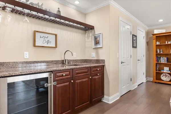 a bathroom with a granite countertop sink a mirror and cabinets