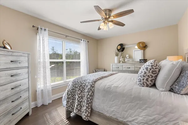 a bedroom with a large bed and a window