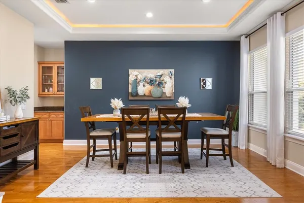 a dining room with furniture a rug and a window