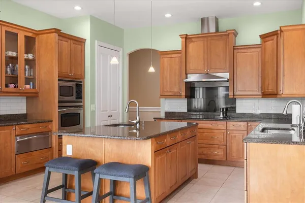 a kitchen with stainless steel appliances granite countertop a sink and cabinets