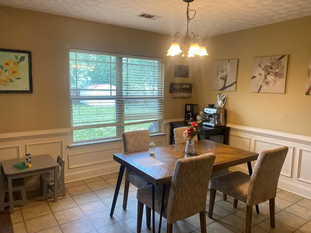 a view of a dining room with furniture and window