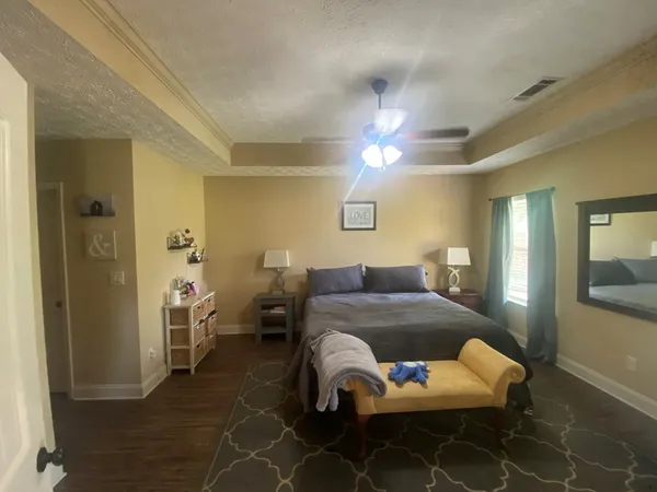 a bedroom with a bed and a chandelier