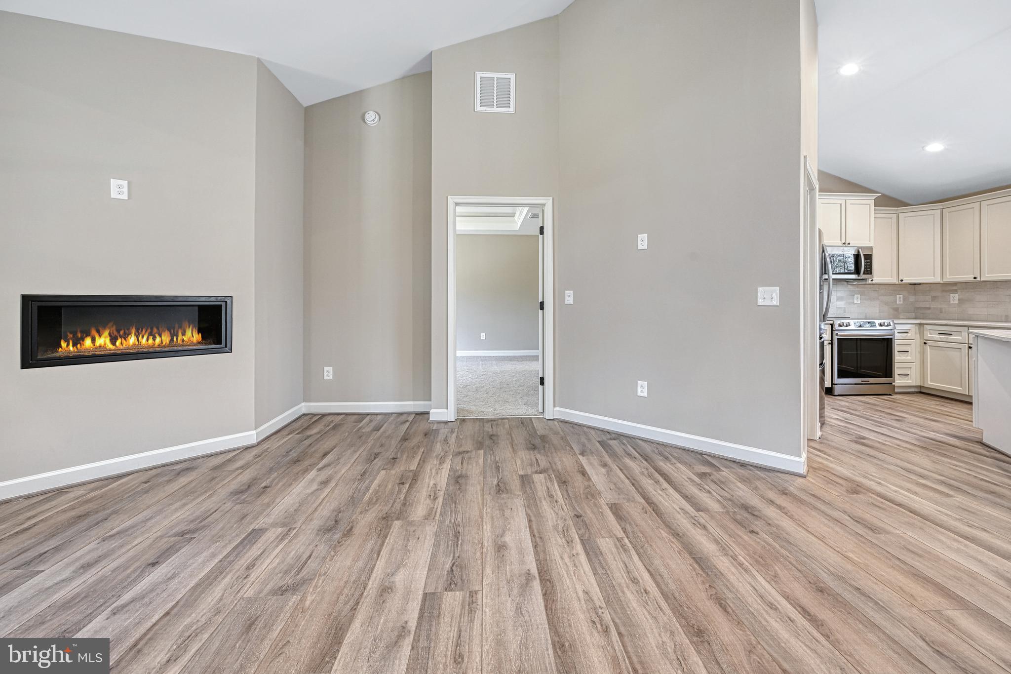 48 Pine Drive Louisa, VA 23093 - Photo 20 of 76 a view of a kitchen with a fridge and wooden floor