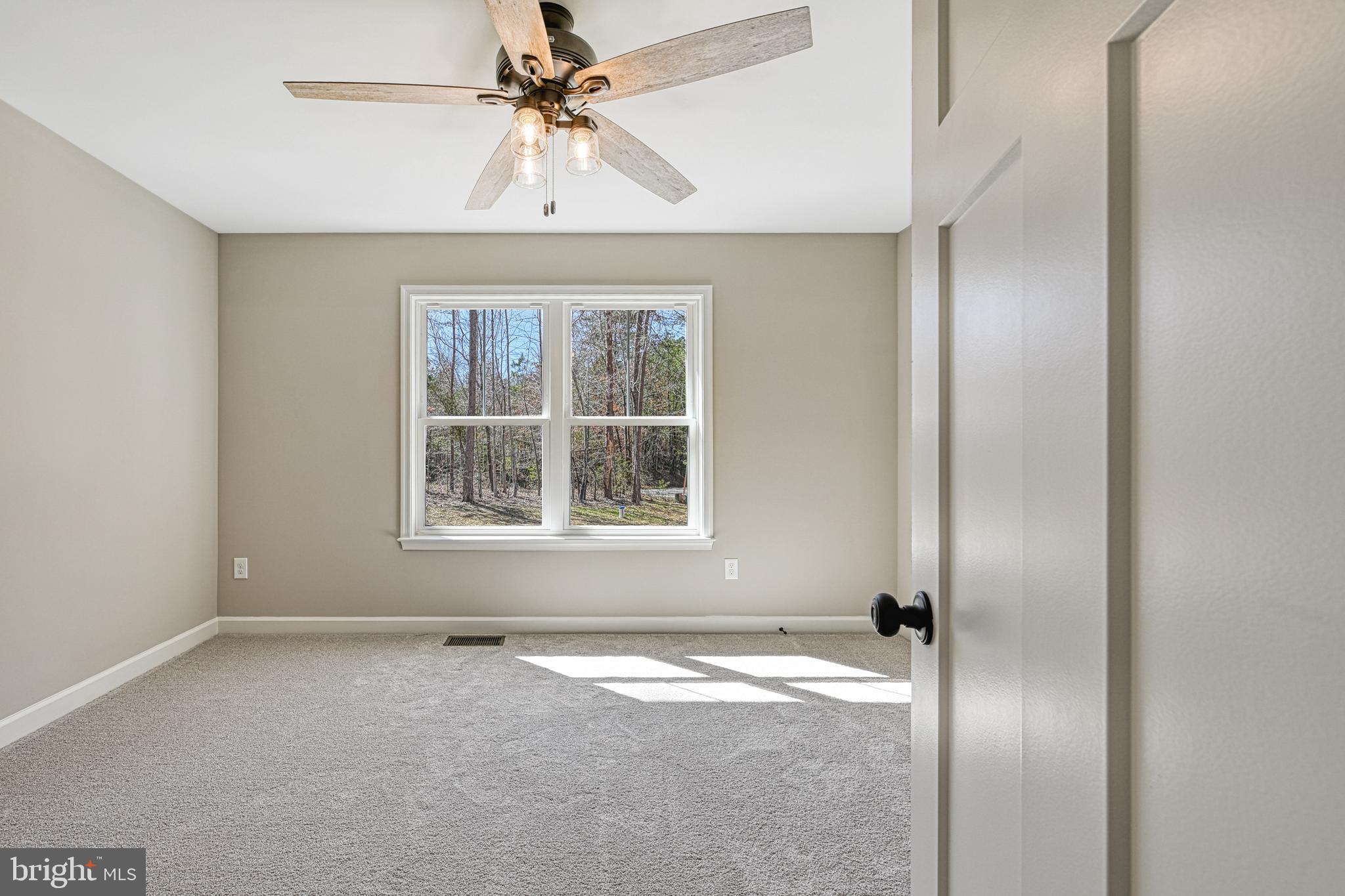 48 Pine Drive Louisa, VA 23093 - Photo 37 of 76 an empty room with a window and a fan