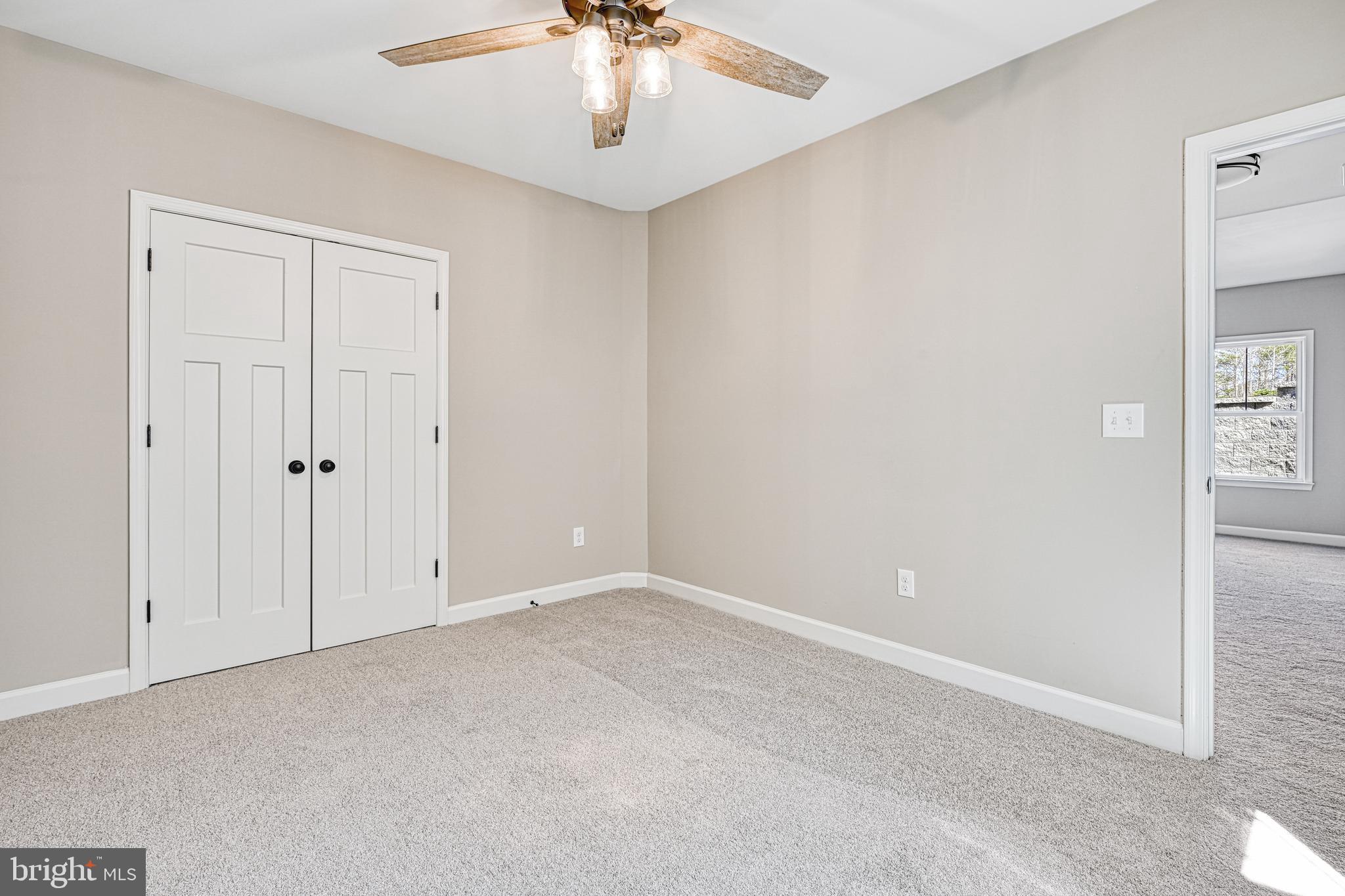 48 Pine Drive Louisa, VA 23093 - Photo 56 of 76 an empty room with a chandelier fan
