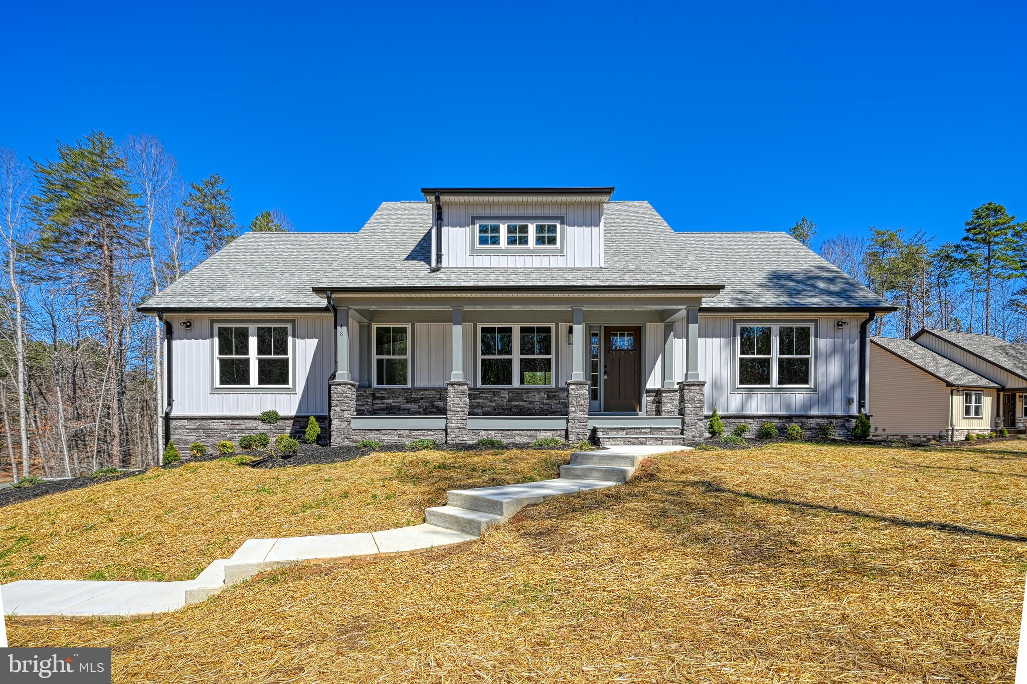 48 Pine Drive Louisa, VA 23093 - Photo 58 of 76 a front view of a house with a garden and yard