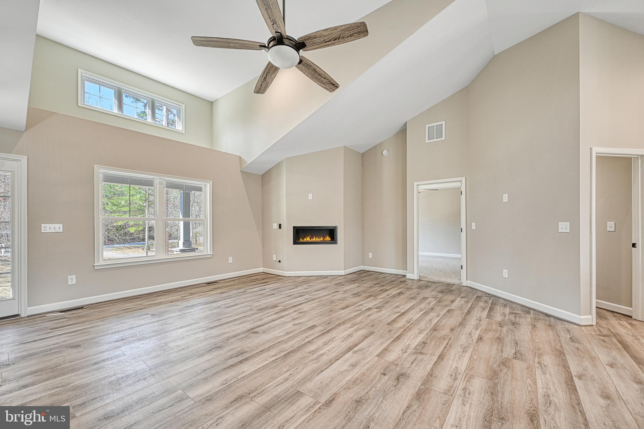 48 Pine Drive Louisa, VA 23093 - Photo 7 of 76 a view of an empty room with a window and a chandelier fan