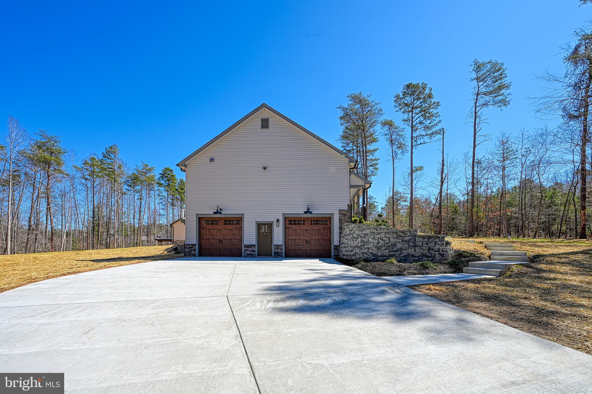 48 Pine Drive Louisa, VA 23093 - Photo 74 of 76 a view of a house with palm trees and a small yard