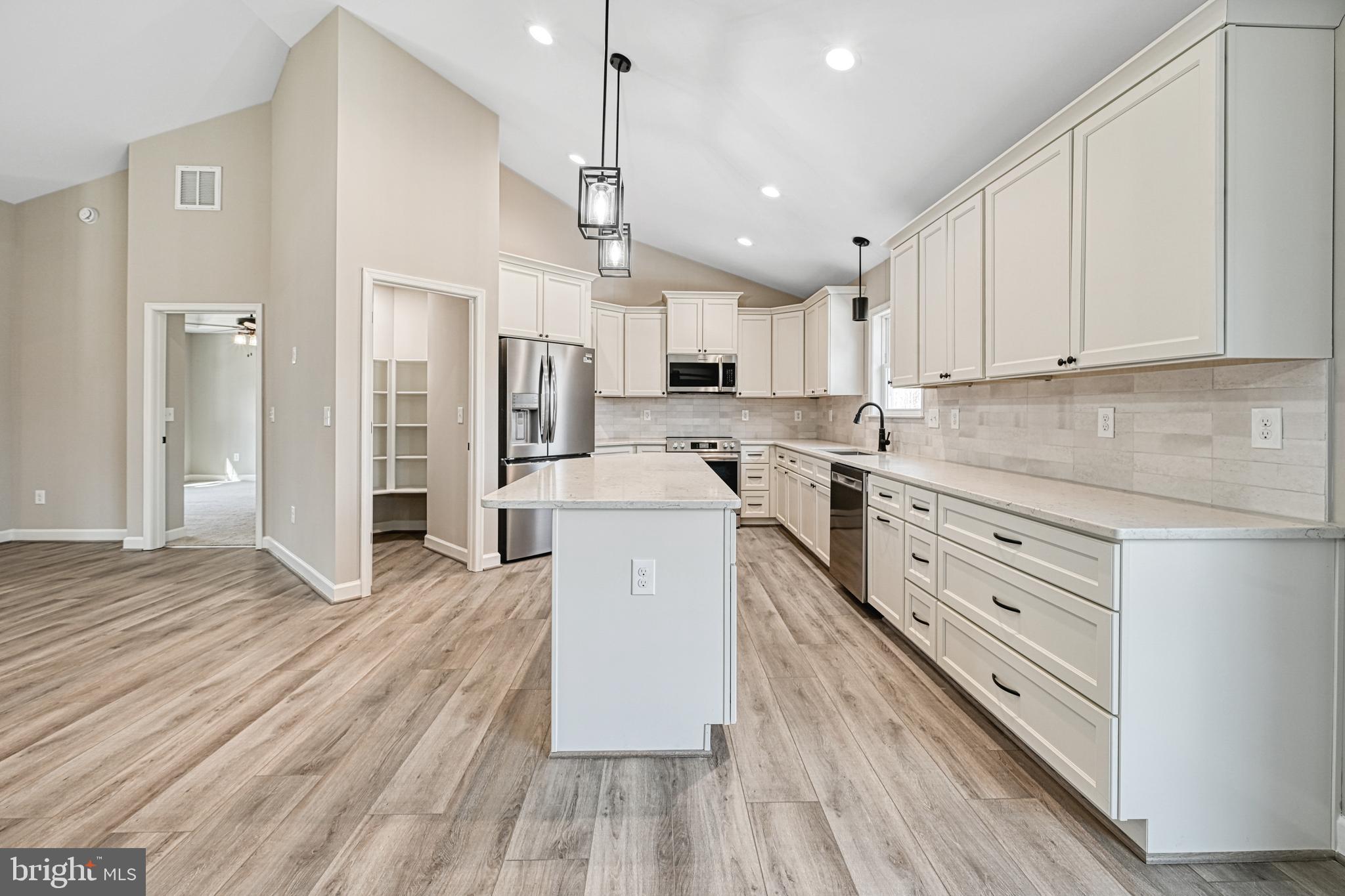 48 Pine Drive Louisa, VA 23093 - Photo 10 of 76 a kitchen with stainless steel appliances a refrigerator sink and cabinets