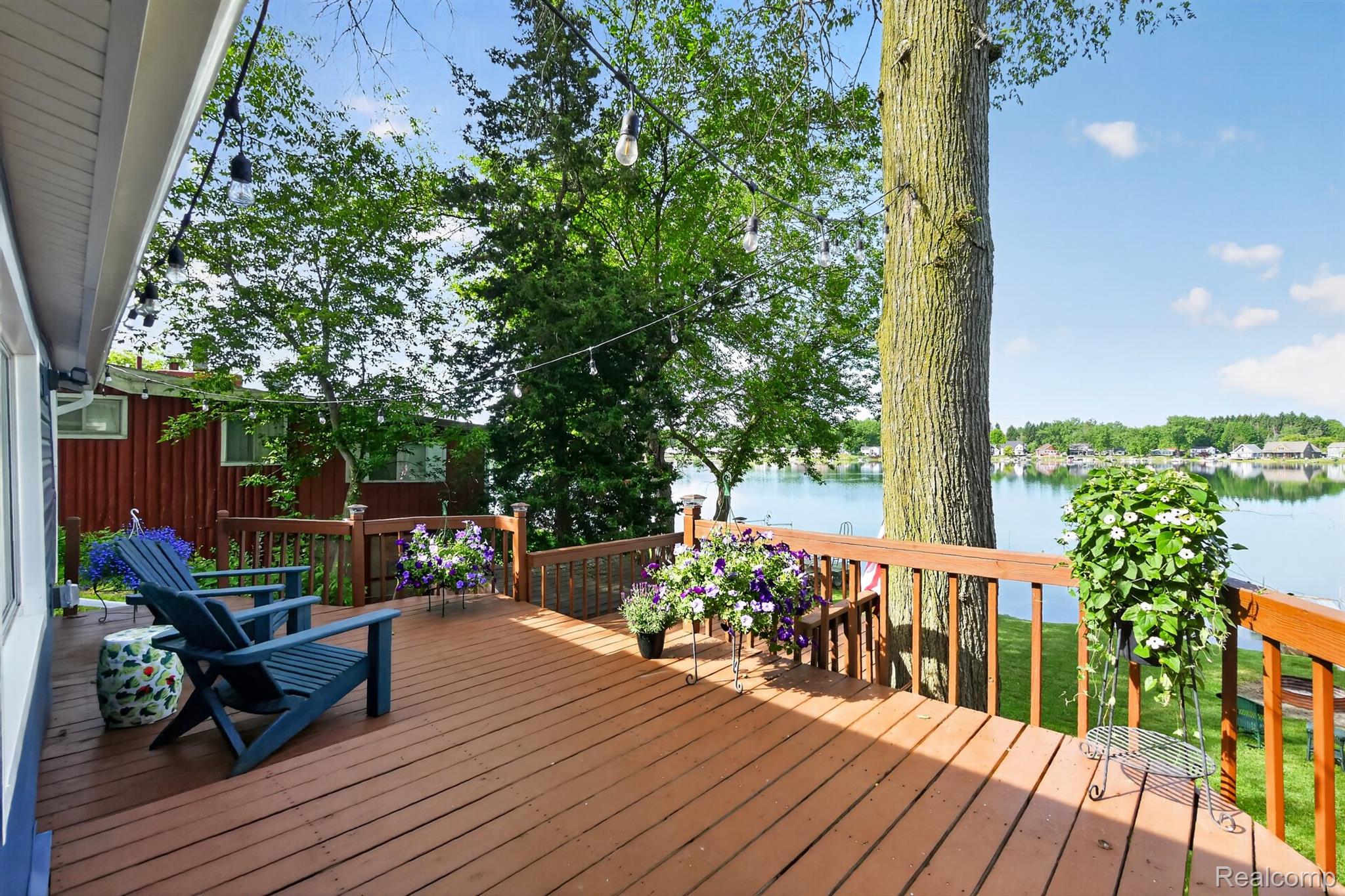 1717 Triangle Lake Road Howell, MI 48843 - Photo 5 of 58 Expansive outdoor deck featuring wood-finish flooring and a wood railing