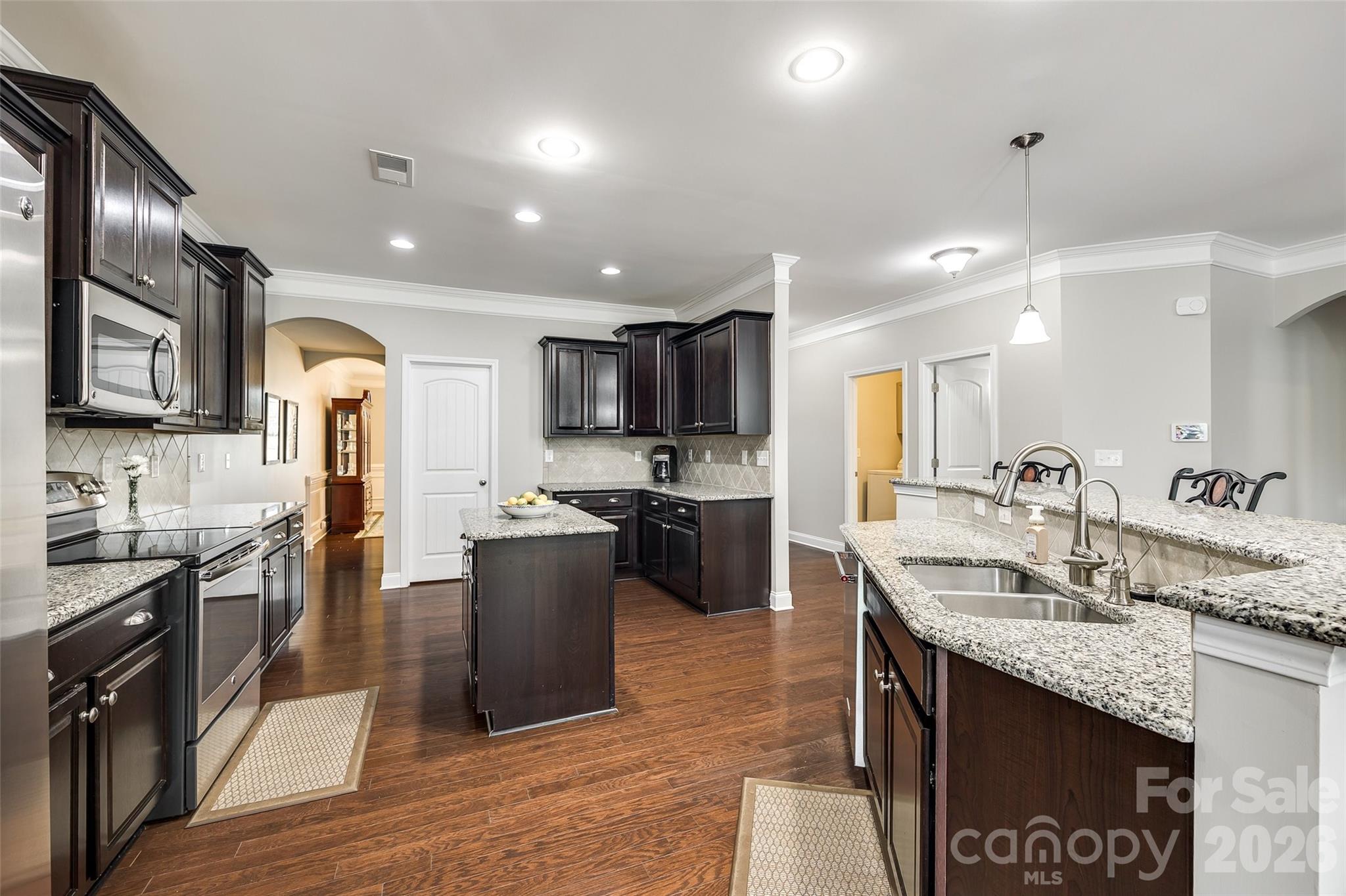 1129 Black Walnut Road Clover, SC 29710 - Photo 12 of 40 a kitchen with stainless steel appliances granite countertop a sink stove and refrigerator